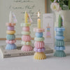 A set of handcrafted soy wax aromatherapy candles in pastel colors arranged in a vertical stack.