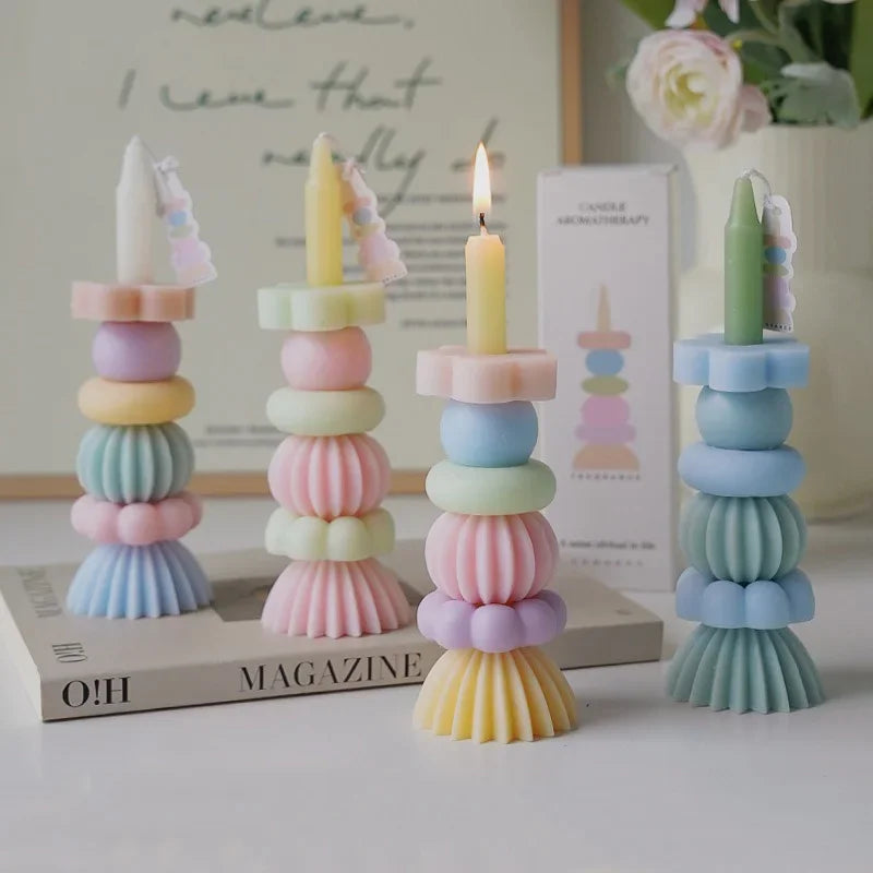 A set of handcrafted soy wax aromatherapy candles in pastel colors arranged in a vertical stack.