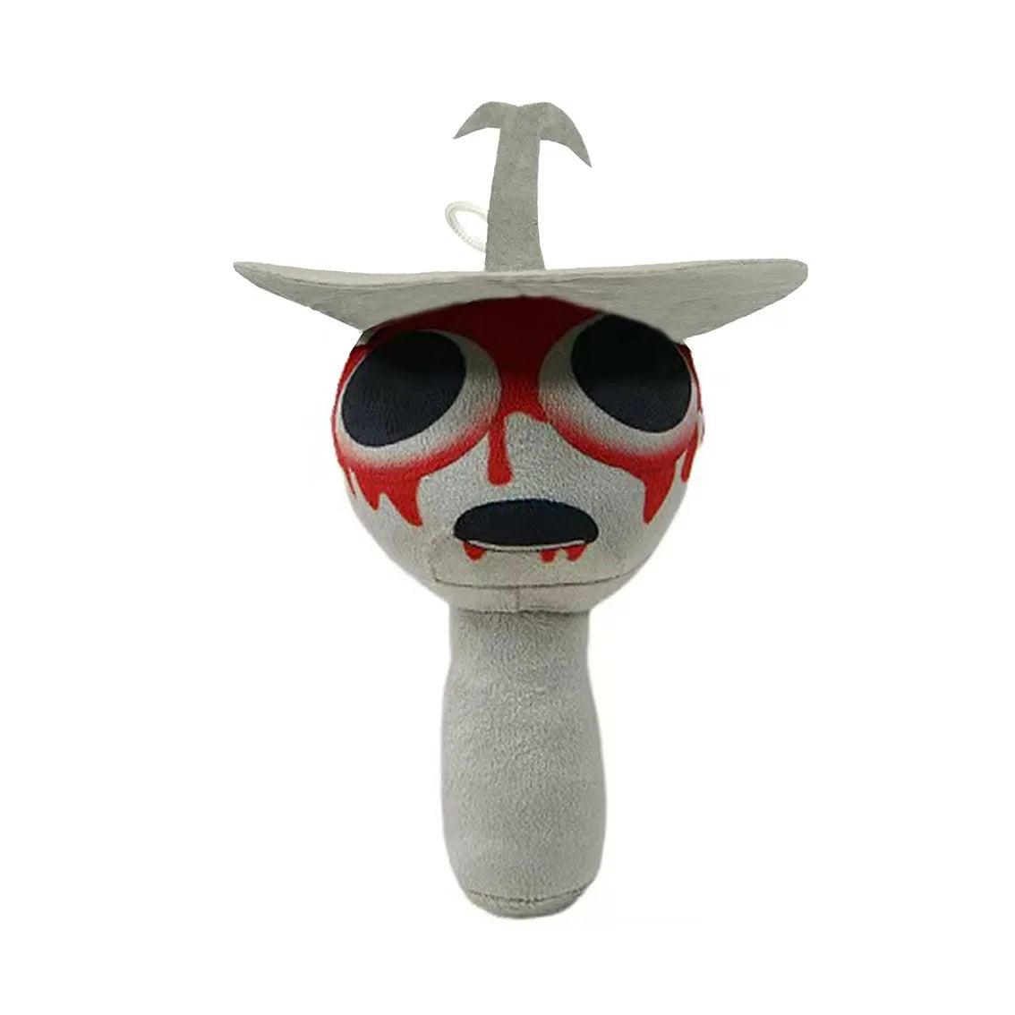 A plush toy featuring a stylized, grotesque face with red markings and a small, upward-pointing protrusion.