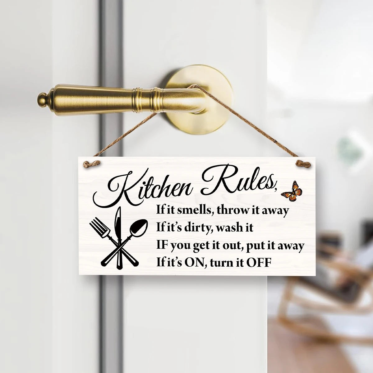 A wooden hanging sign with text listing kitchen rules such as throwing away smelly items and turning off appliances.