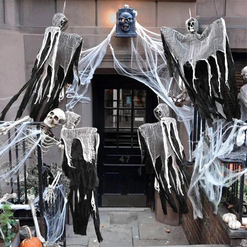 A set of spooky Halloween ghost and skeleton hanging decor featuring black and white figures on a dark doorway.