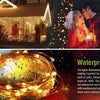 A close-up of warm yellow fairy string lights wrapped in a circular shape, designed for waterproof outdoor use.