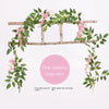 Pink wisteria vine garland draped over a wooden trellis for wedding and home decor
