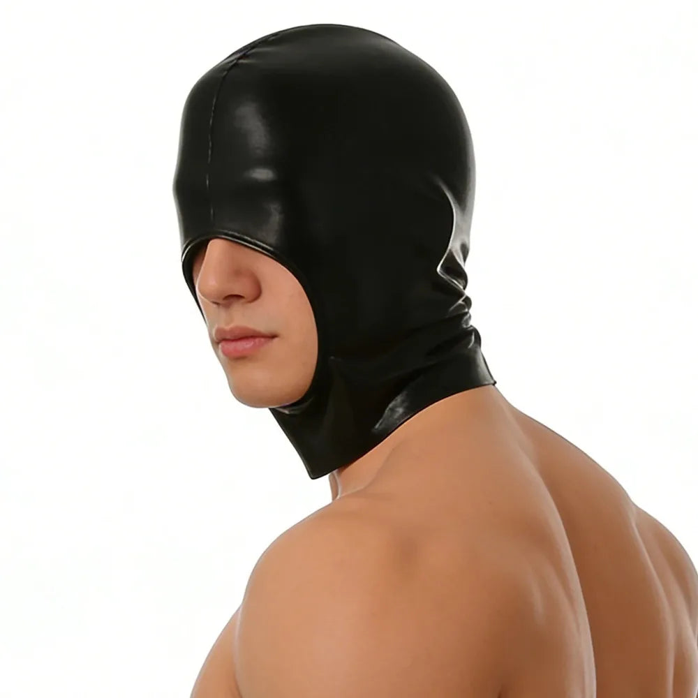A close-up of a male model wearing a black faux leather hood mask with a blindfold.
