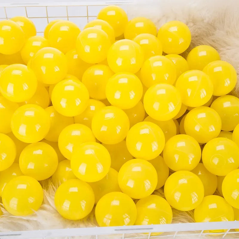 A pile of bright yellow, spherical love star balls for kids' play areas.