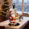 A festive Santa Claus kitchen paper towel holder with a red and white design sits on a white tablecloth.