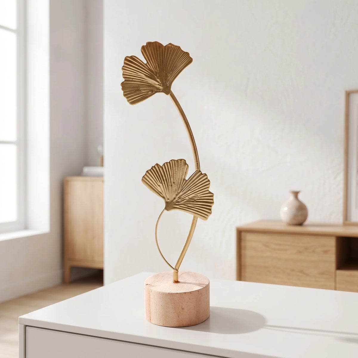 A delicate gold-toned iron ginkgo leaf ornament set displayed on a white surface.