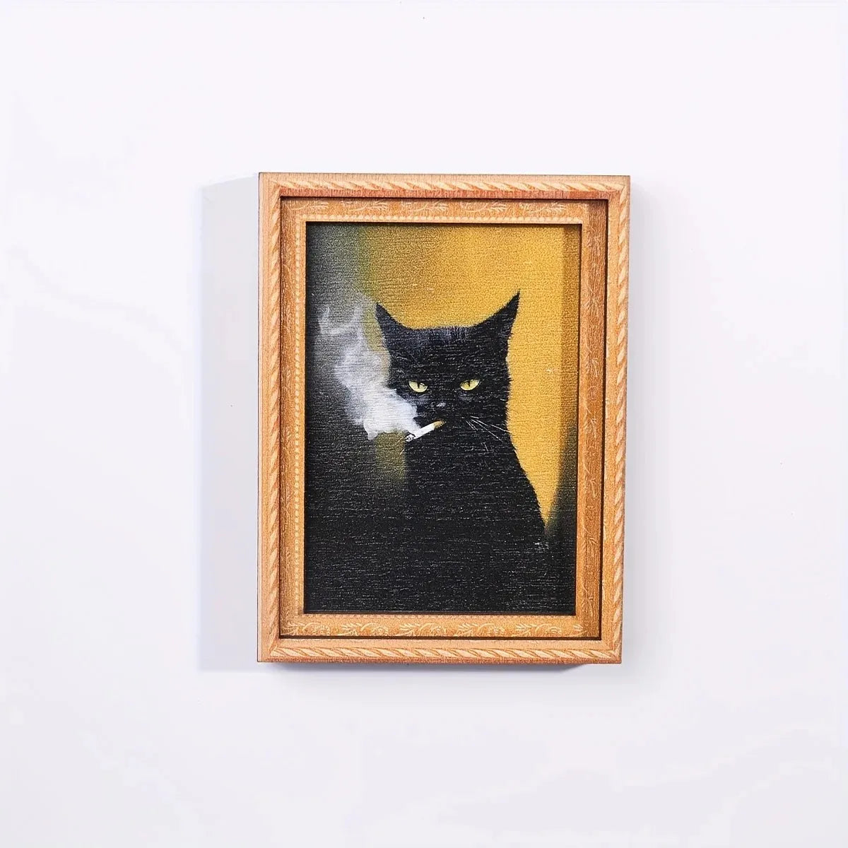 A framed black cat silhouette with wisps of smoke against a yellow background.
