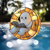 A hanging decoration shaped like a ghost reading an open book, made of stained glass.