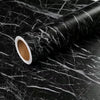 Roll of matte marble self-adhesive waterproof wallpaper with white core on a dark marbled surface