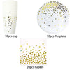 A set of gold polka dot disposable party tableware including cups, plates, and napkins.