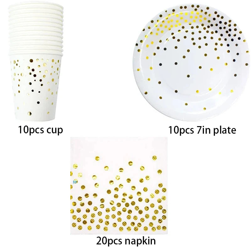 A set of gold polka dot disposable party tableware including cups, plates, and napkins.