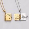 A pair of gold and silver openable book pendant necklaces featuring engraved messages.