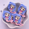 A set of five pastel blue and pink resin figurines depicting mermaid princesses with wavy hair.