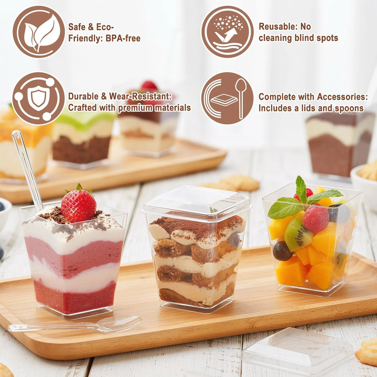 A set of 50 clear plastic dessert cups with lids and spoons displayed on a wooden board.