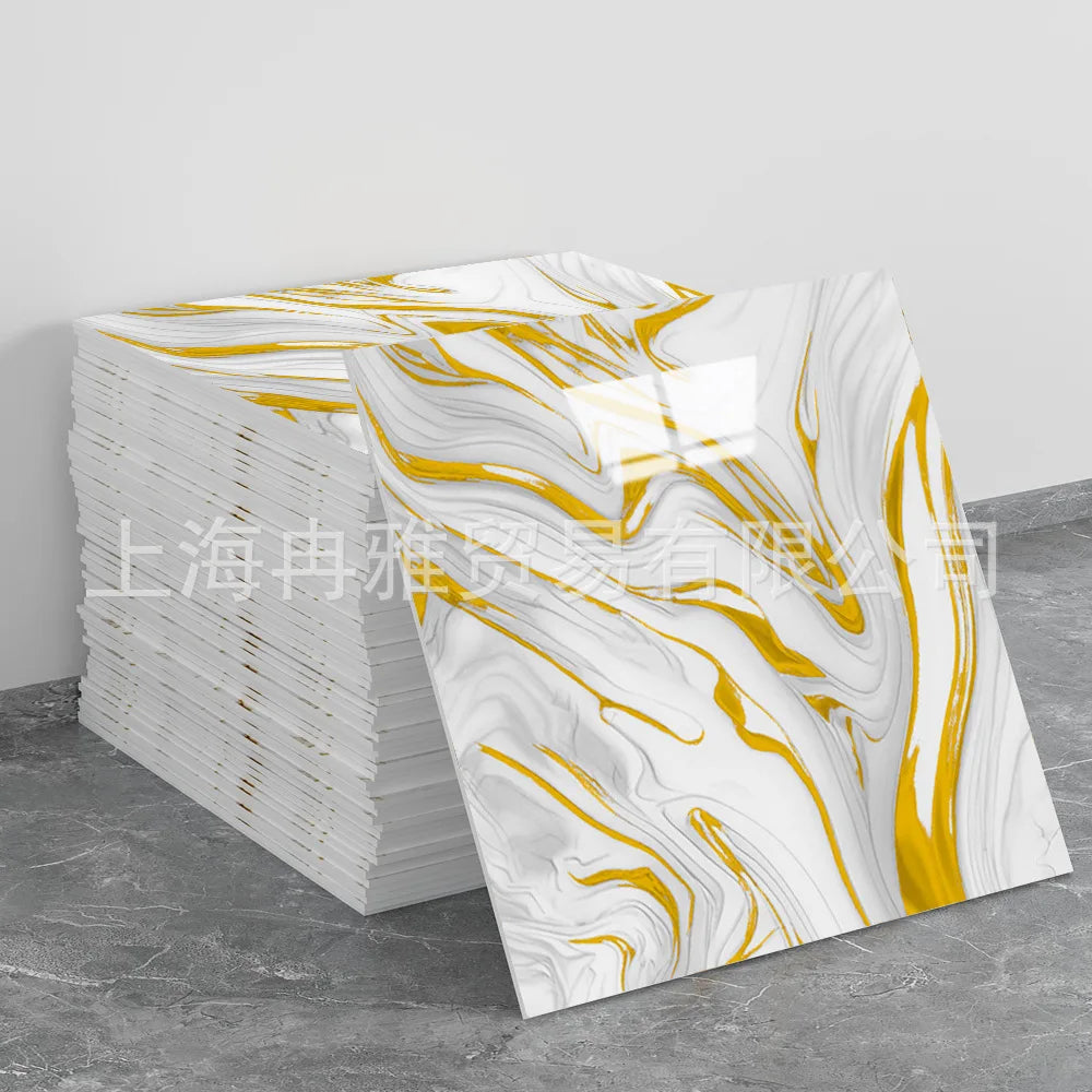 Stack of faux marble self-adhesive wall tiles featuring white and gold swirling patterns.