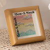 A wooden photo frame displaying a landscape painting with text indicating dimensions 15cm-5.9inch.