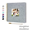 A grey linen cover scrapbook album with a gold spiral binding and a photo of a couple.