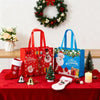 Red and blue festive gift bags with Christmas themes displayed on a red table.