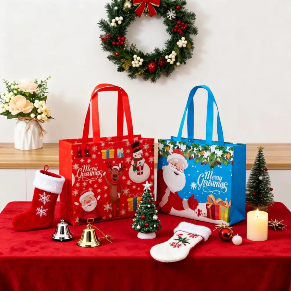 Red and blue festive gift bags with Christmas themes displayed on a red table.