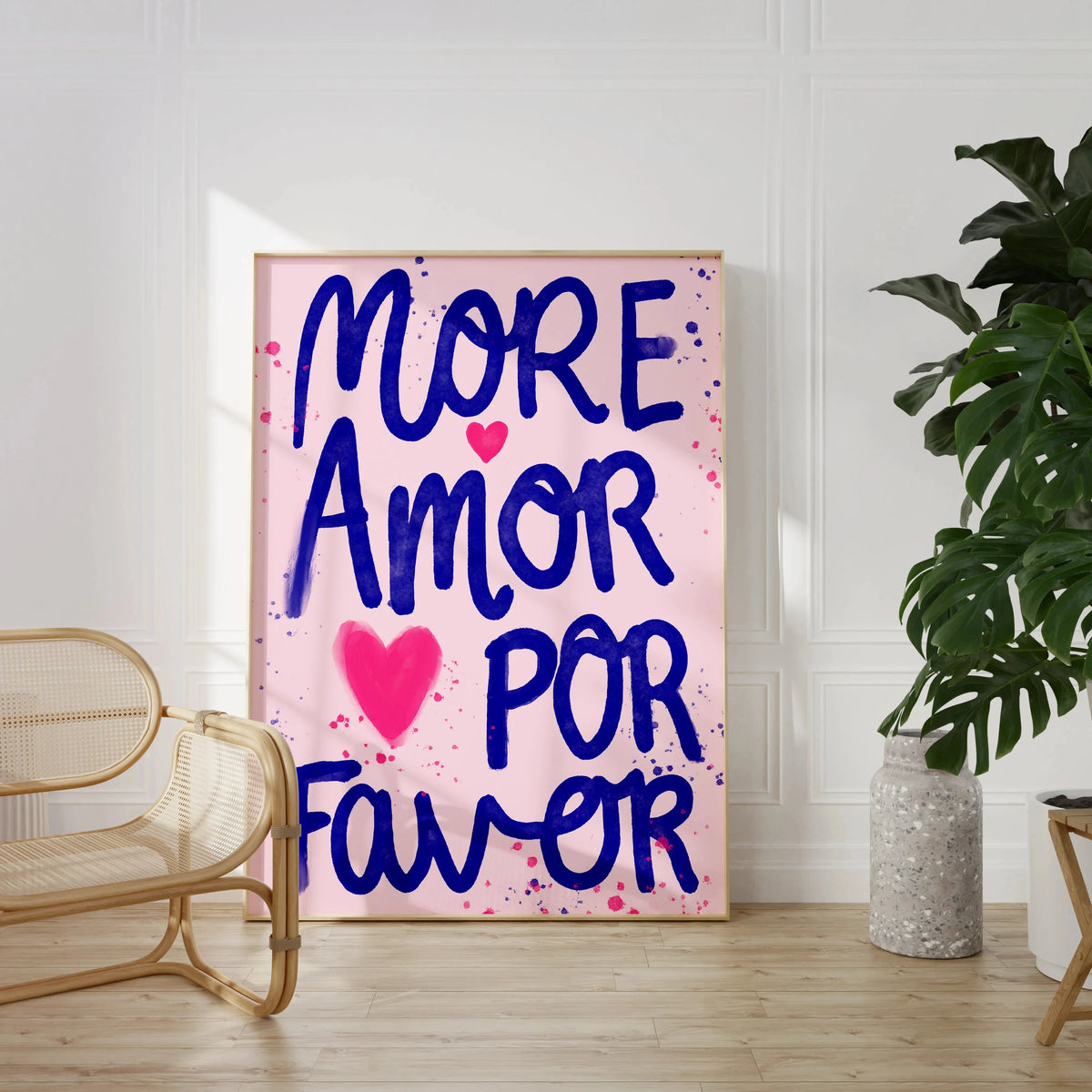 Pink canvas wall art featuring the text MORE AMOR POR FAVOR in blue script with pink heart accents.