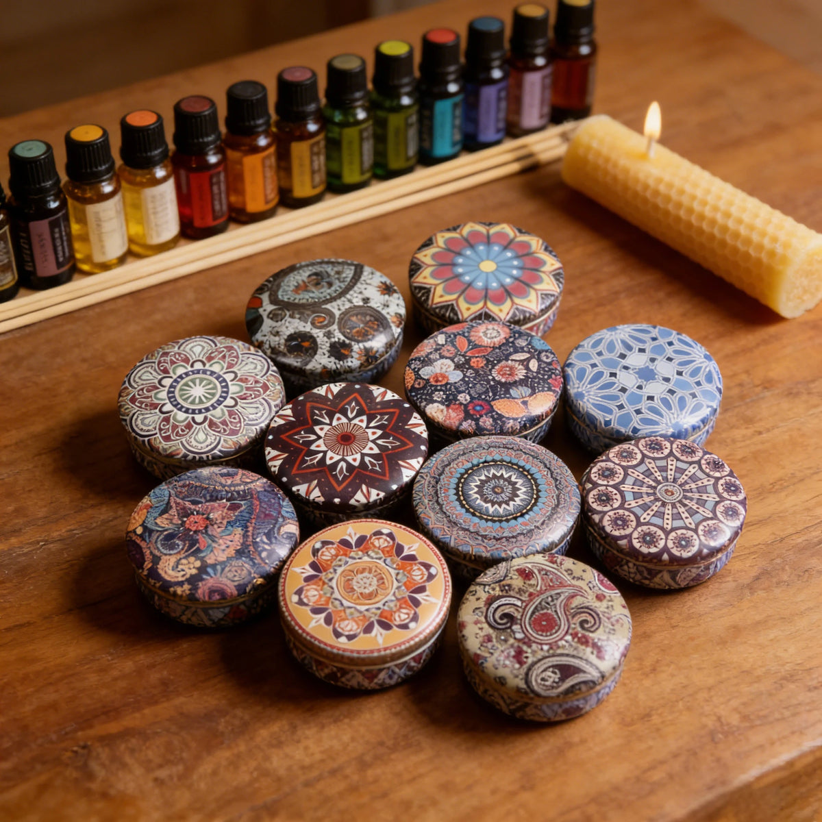 A collection of decorative soy wax candles in various colors and patterns arranged on a wooden surface next to a candle.