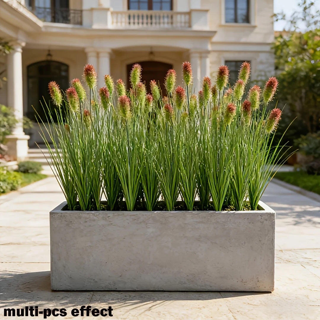 A rectangular planter filled with artificial grass stems used for home decor