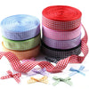 Rolls of red, pink, blue, and green gingham ribbon for gift wrapping and party decor