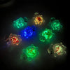 A collection of glow-in-the-dark mini sea turtle figurines in various colors including green, blue, and orange.