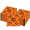 Orange paper napkins featuring a pattern of carved jack-o'-lanterns and spiders.