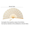 A vintage lace hand fan in cream color with a gold-toned wooden handle and tassel pendant.