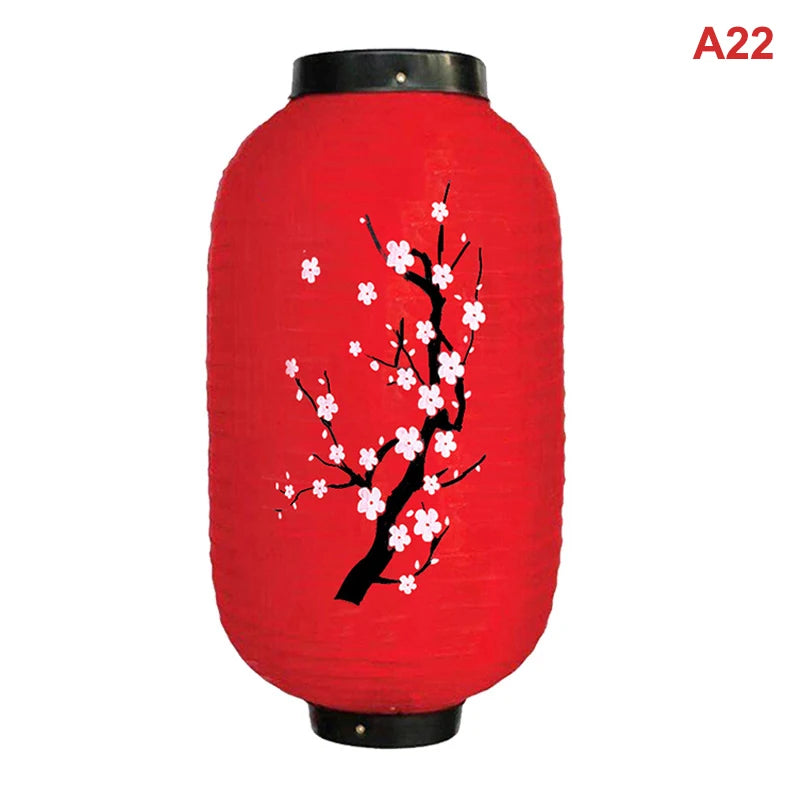 A red paper hanging lantern decorated with white cherry blossoms.