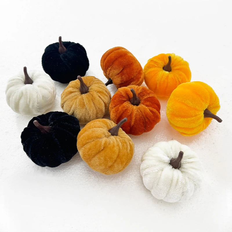 A set of five foam pumpkins in various colors including black, white, orange, and gold, displayed on a white surface.
