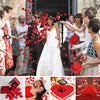 A collection of vibrant red silk rose petals used for weddings and events.