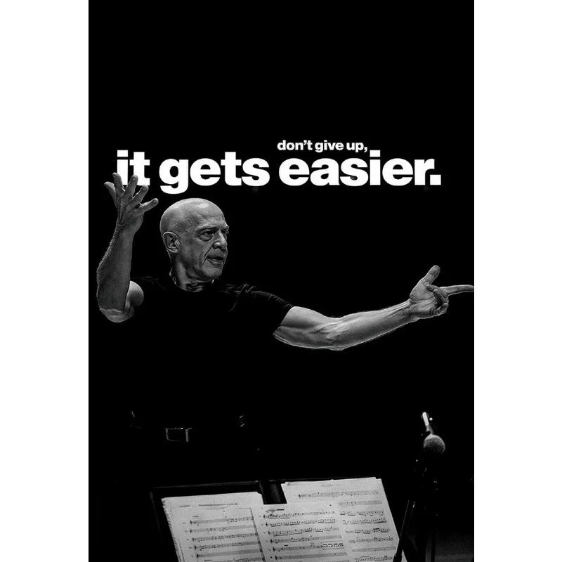 A black and white motivational image featuring a man with a determined expression against a dark background.