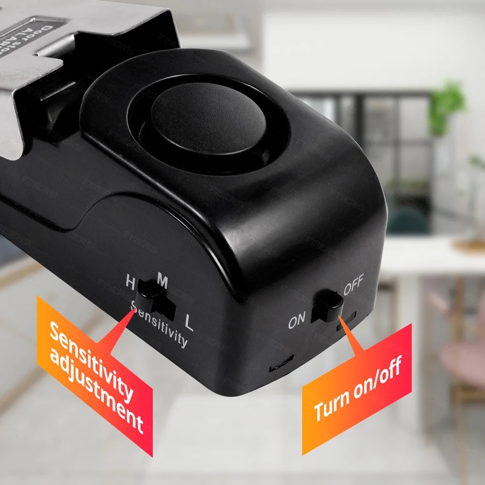 A black dual door stop security alarm set with sensitivity adjustment and on/off controls.