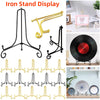 A collection of black and gold metal iron stand displays for showcasing photos, plates, and collectibles.