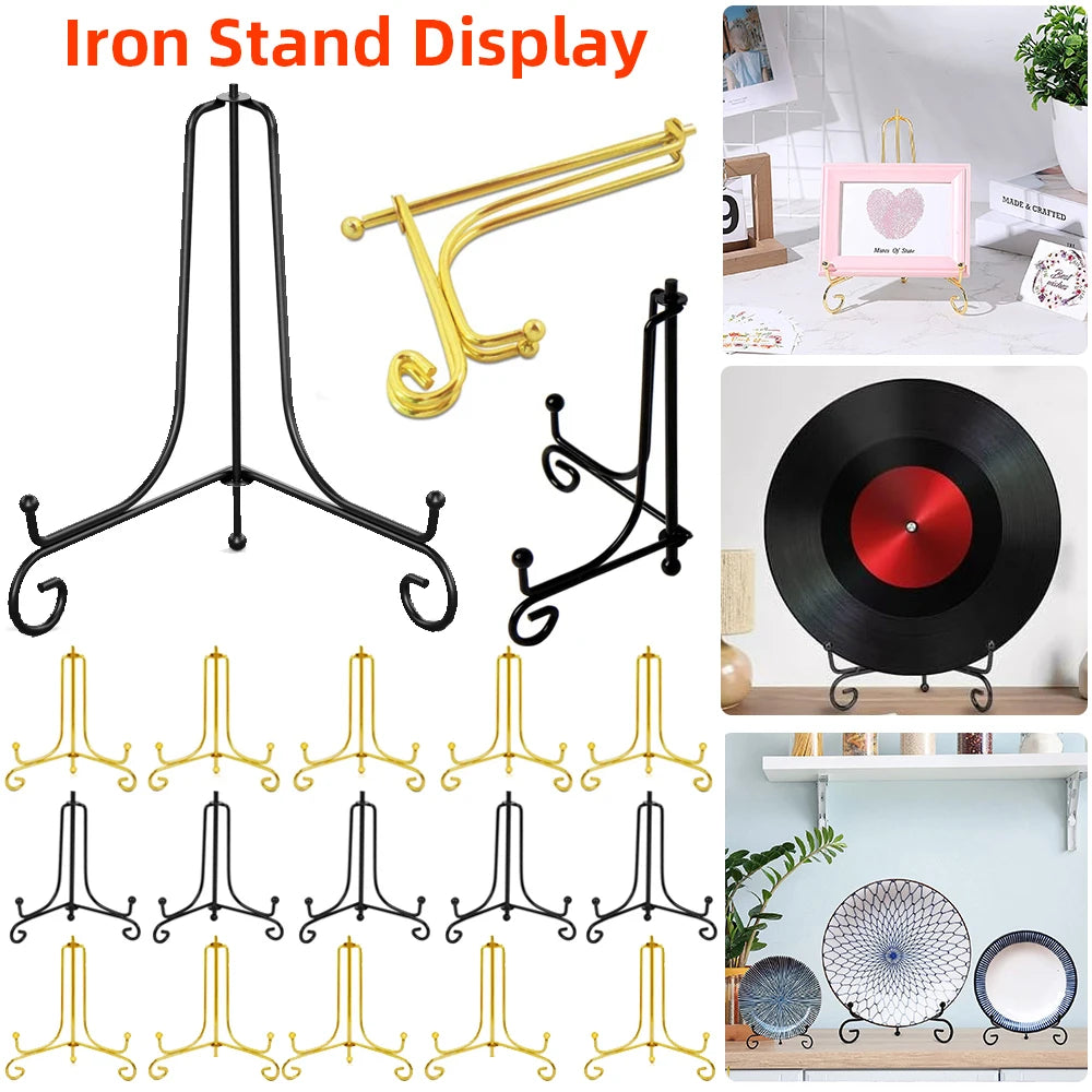 A collection of black and gold metal iron stand displays for showcasing photos, plates, and collectibles.