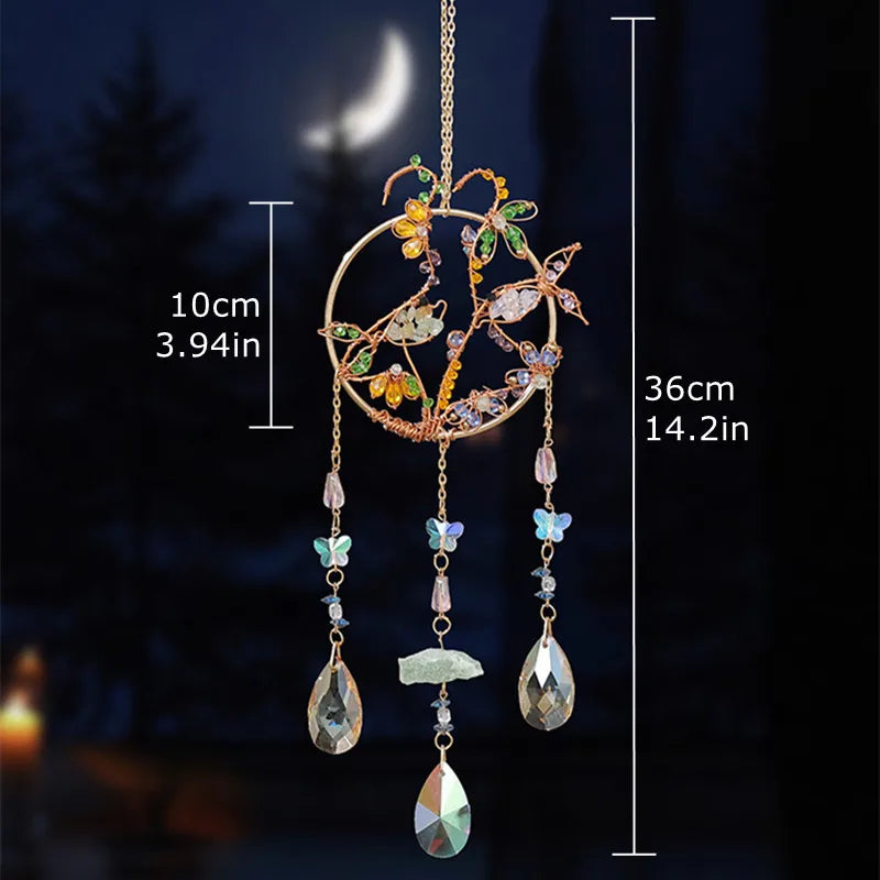 A hanging crystal tree of life sun catcher featuring gold wire and various colored crystals and leaves.