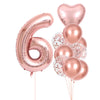 A set of rose gold foil balloons shaped like the number six and several round balloons with gold confetti for party decor