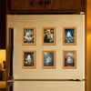 A white refrigerator features several framed magnets depicting cute ghost Halloween figures in retro photo frames.
