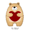 A tan bear-shaped balloon with a red heart cutout on its chest.