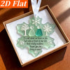 A box containing three sea glass ornaments shaped like snowflakes and figures, presented as a friendship set.