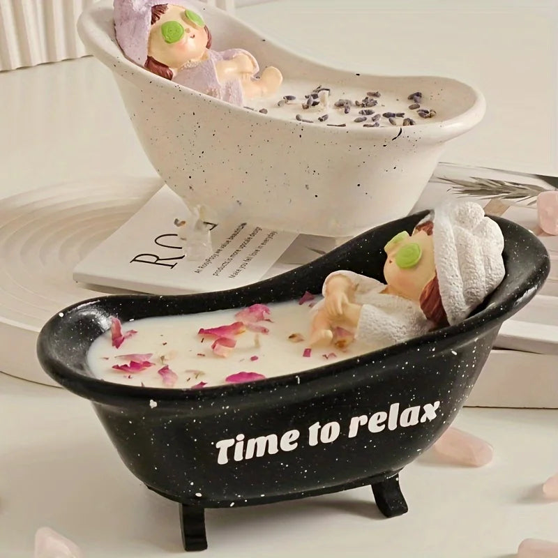 A black silicone mold shaped like a bathtub holds white wax or candle, with a small figure resting inside.