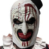 A white horror clown mask with red paint drips and a black top is shown.