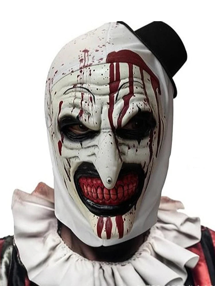 A white horror clown mask with red paint drips and a black top is shown.