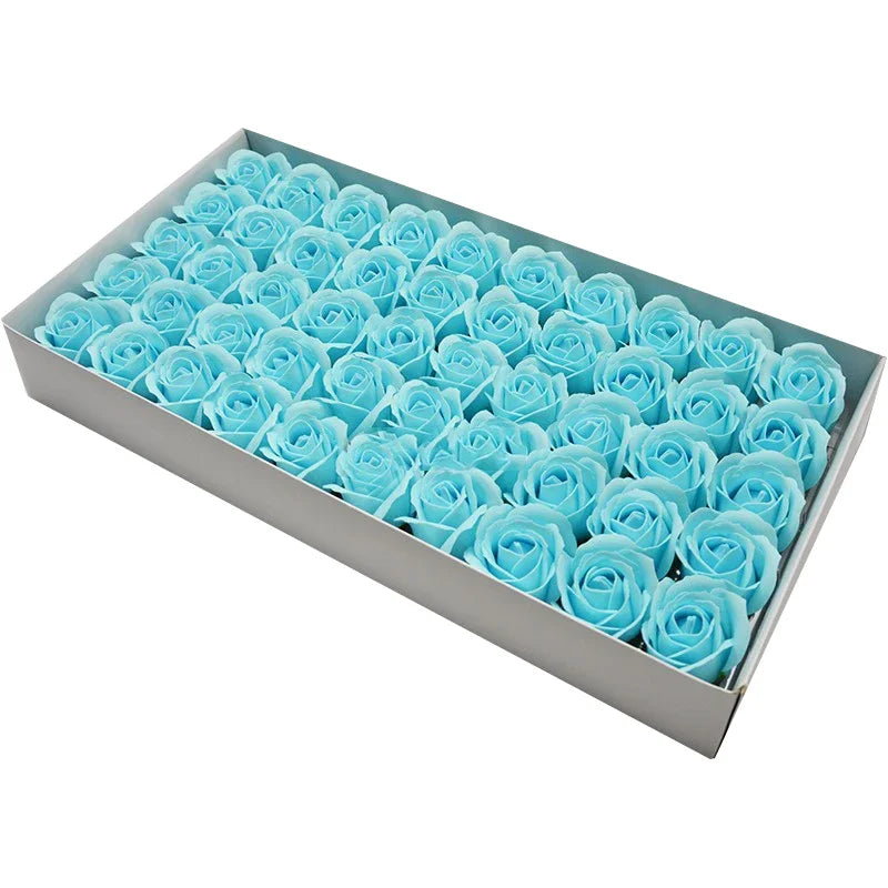 A rectangular box filled with numerous light blue artificial rose heads for wedding and party decor.