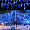 Blue waterfall curtain string lights draped across an outdoor event or venue.