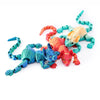 A realistic 3D printed figurine of a Sphynx cat with vibrant orange, pink, and teal coloration.