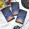 A set of oracle tarot cards with text and imagery resting on white fur.